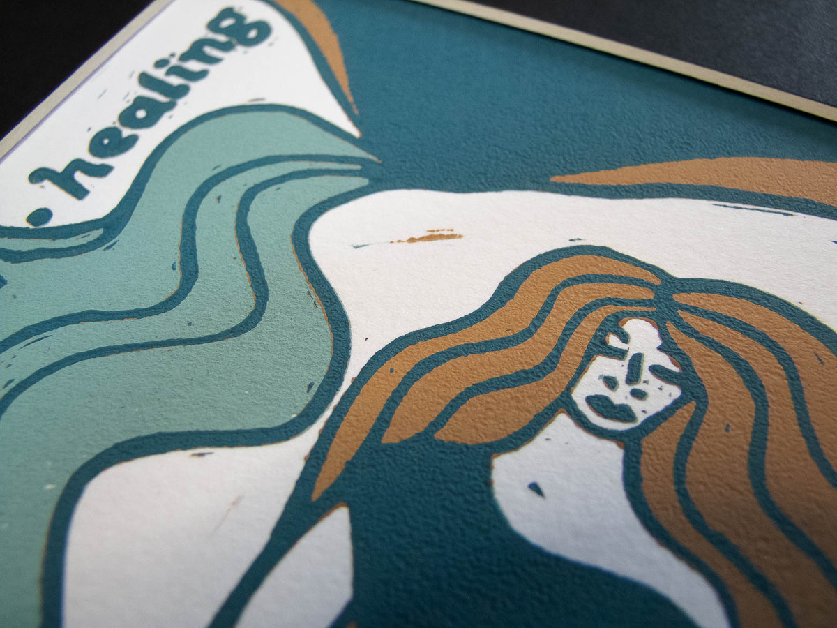 British Mythology linocut print showing a white-faced figure with flowing brown hair against teal and cream shapes
