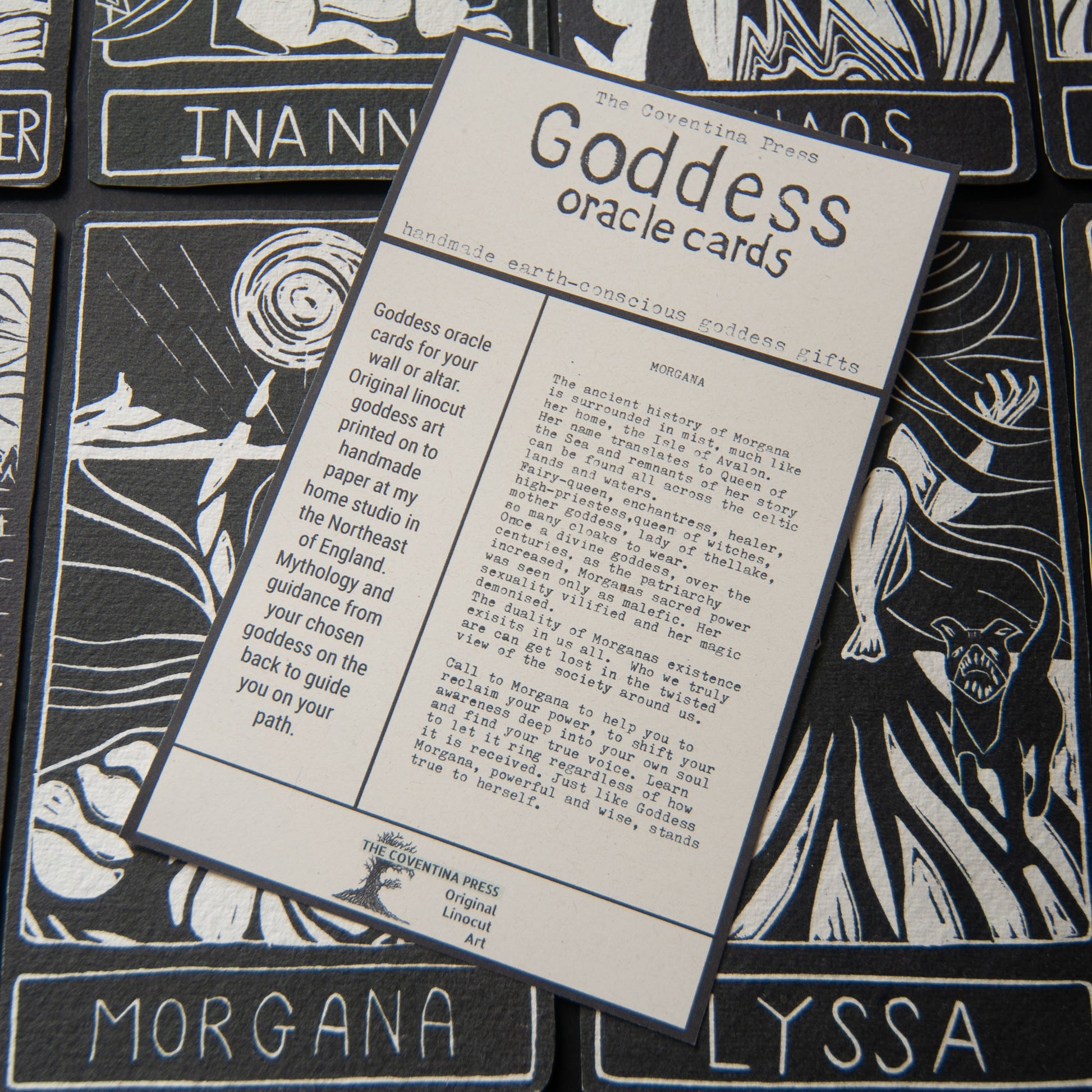 Goddess oracle cards with detailed text on a black and white design background
