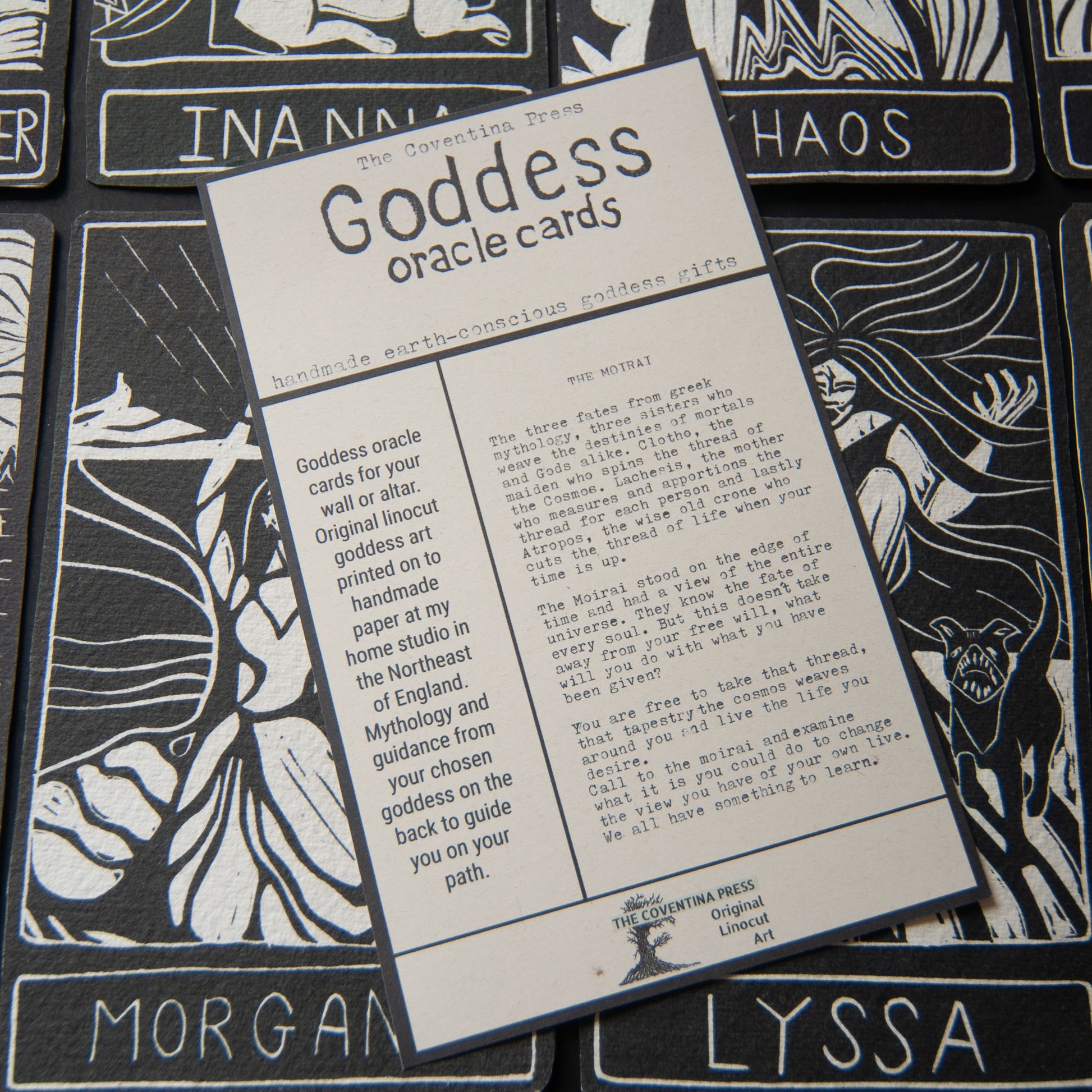 Goddess oracle cards with black and white illustrations and text on a matching card.