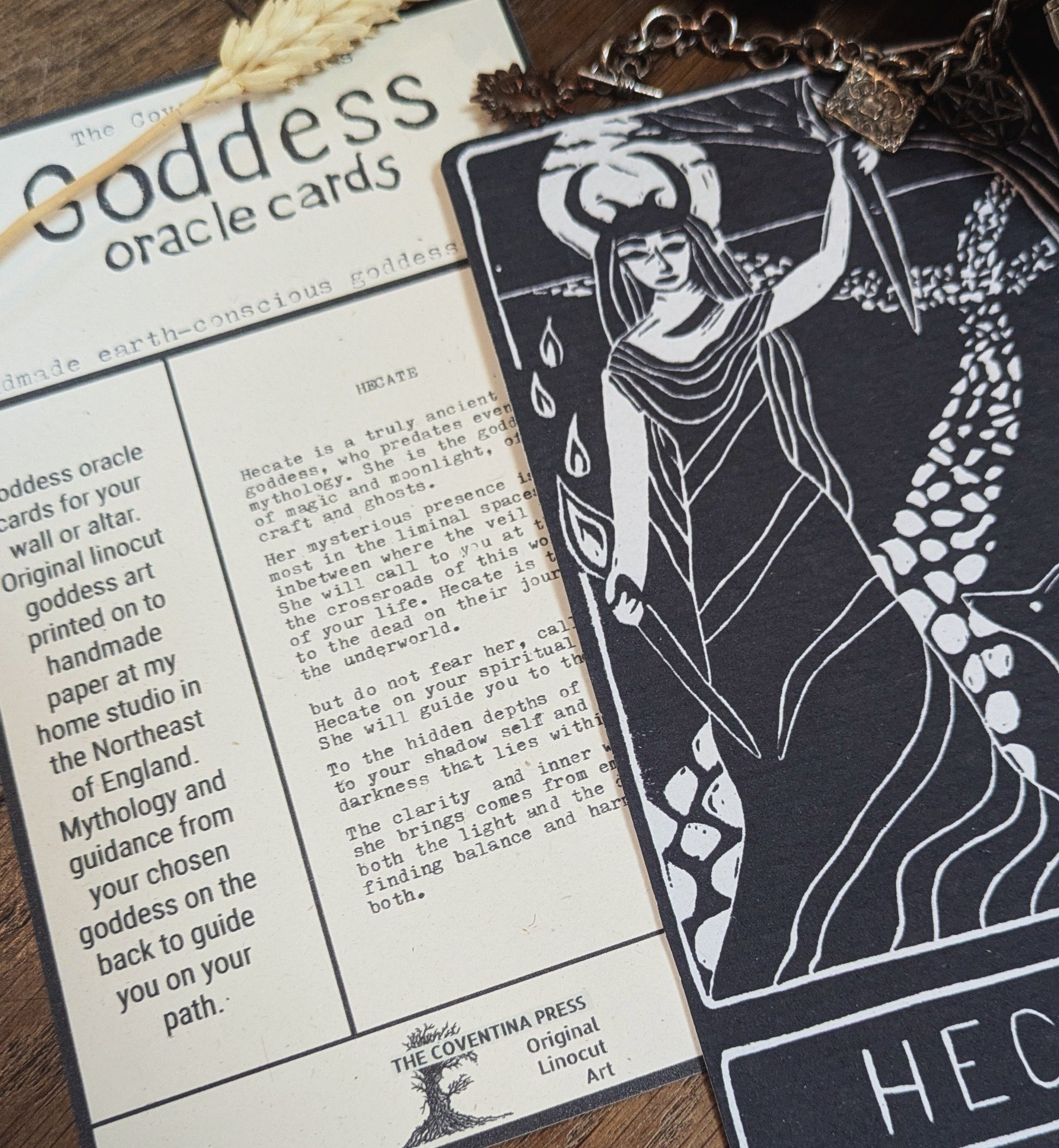 Goddess oracle card with detailed packaging on a wooden surface