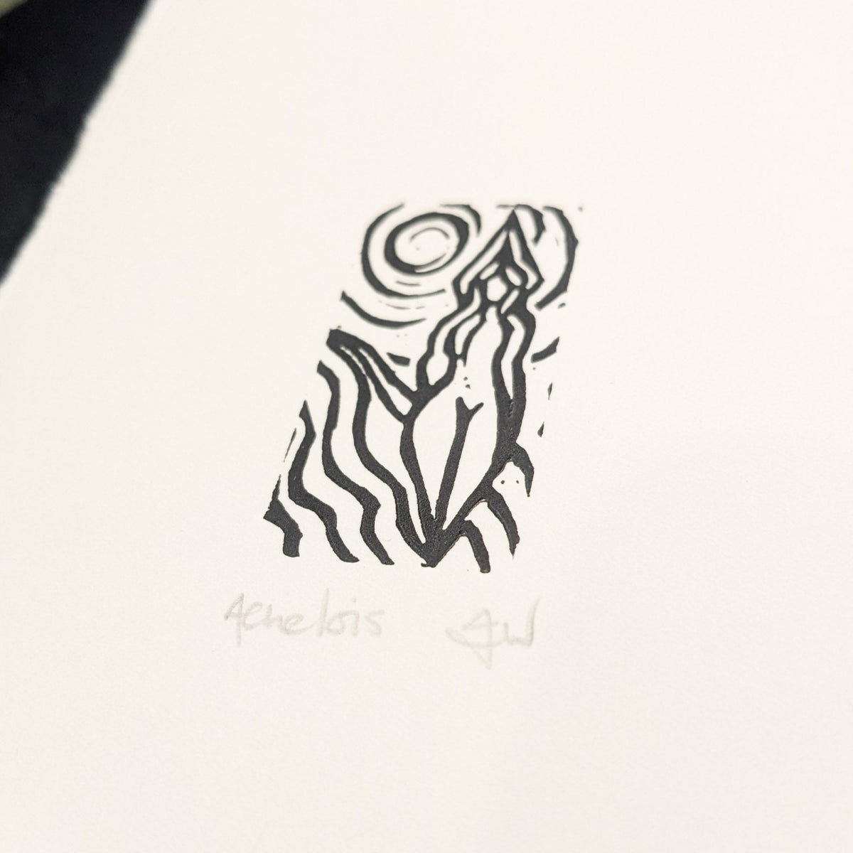 ACHELOIS GREEK MOON GODDESS miniature linocut print in black ink, with a stylized figure and swirling moon motif