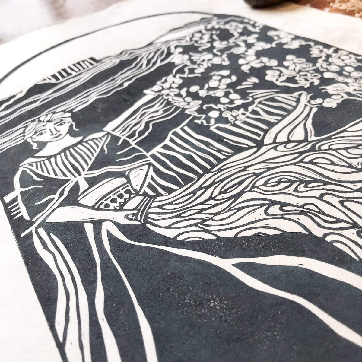 ANAHIT | ARMENIAN GODDESS linocut print in deep blue-grey, showing a seated figure among flowing lines and flowers