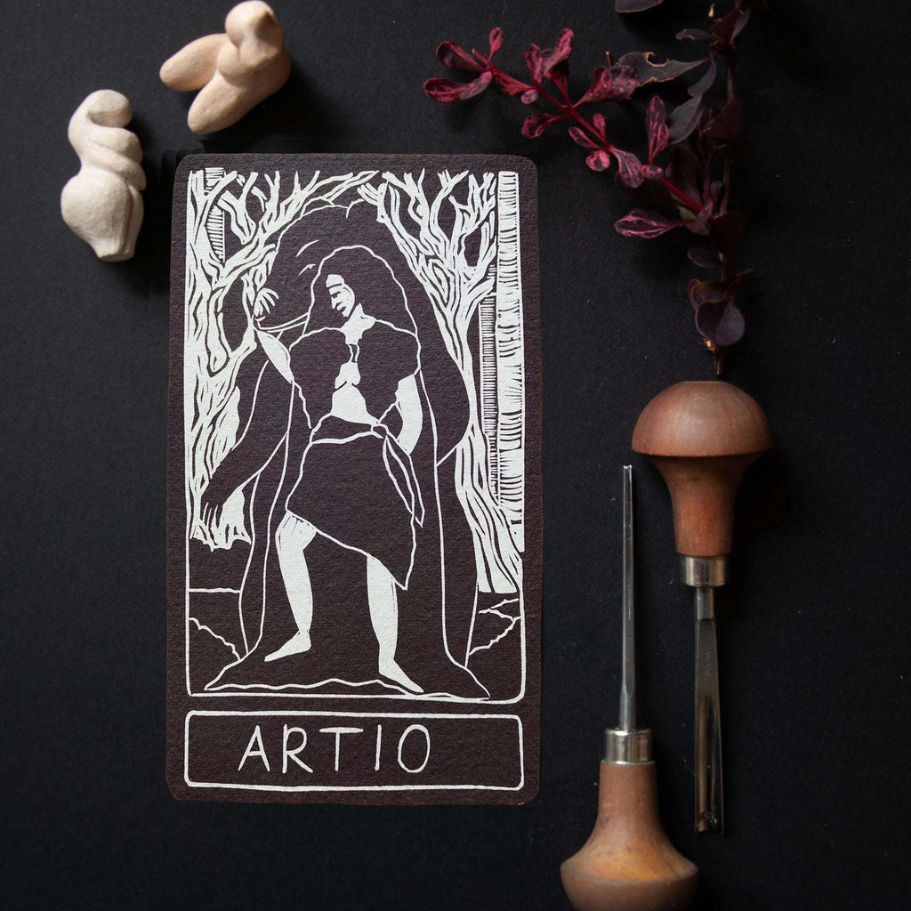 ARTIO ALTAR CARD in black and cream, featuring a white linocut-style figure of Artio among trees and the name ARTIO