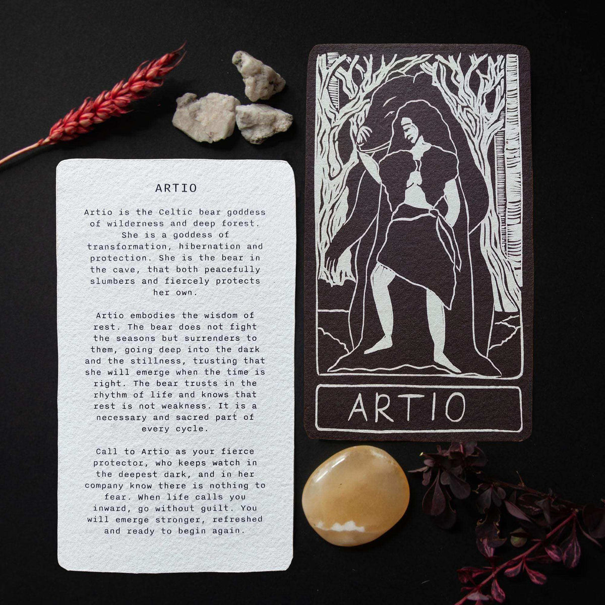ARTIO ALTAR CARD with a black-and-white linocut of a bear goddess among trees and a printed mythology text reverse