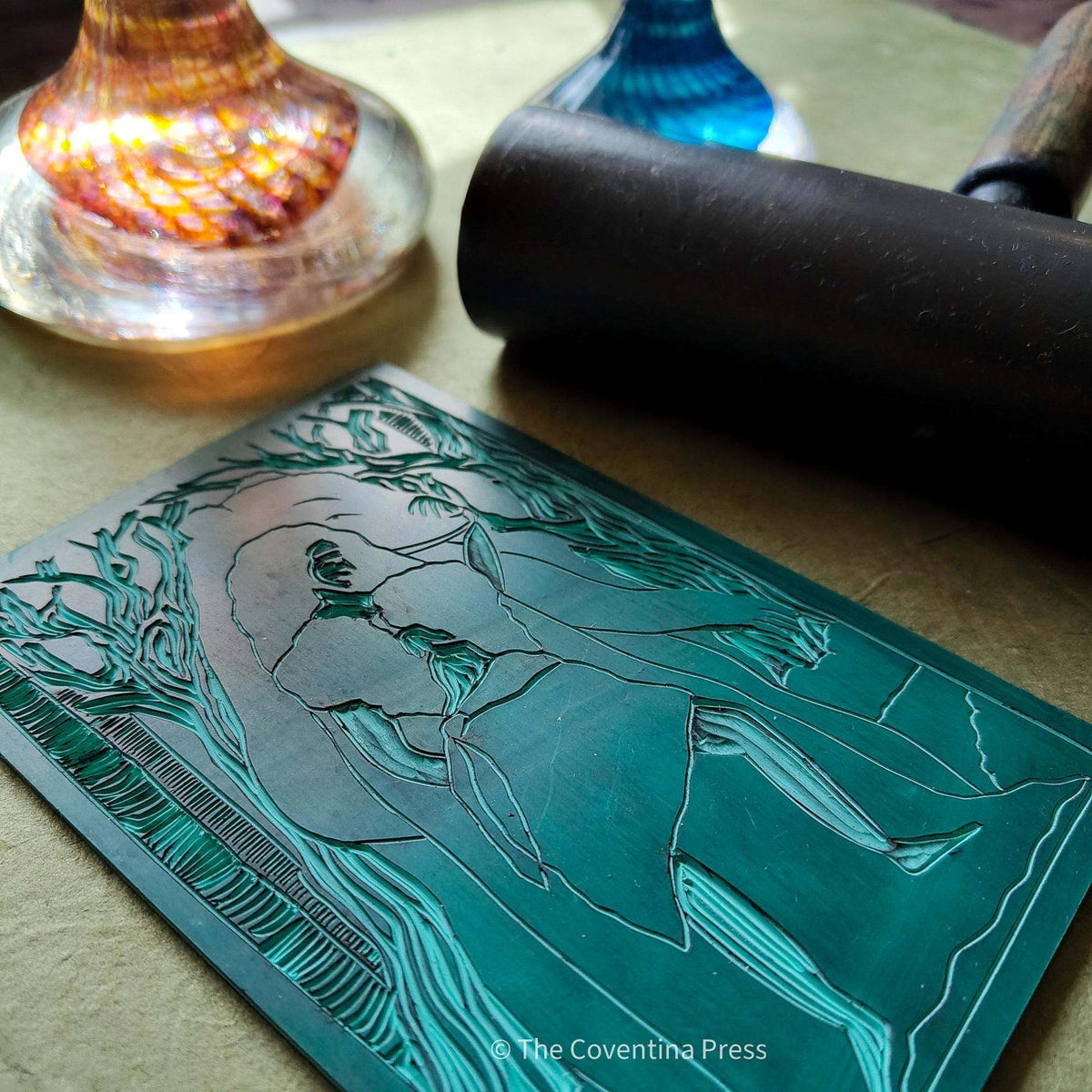 ARTIO ALTAR CARD with a teal linocut design depicting a woman beside a bear, with flowing hair and trees