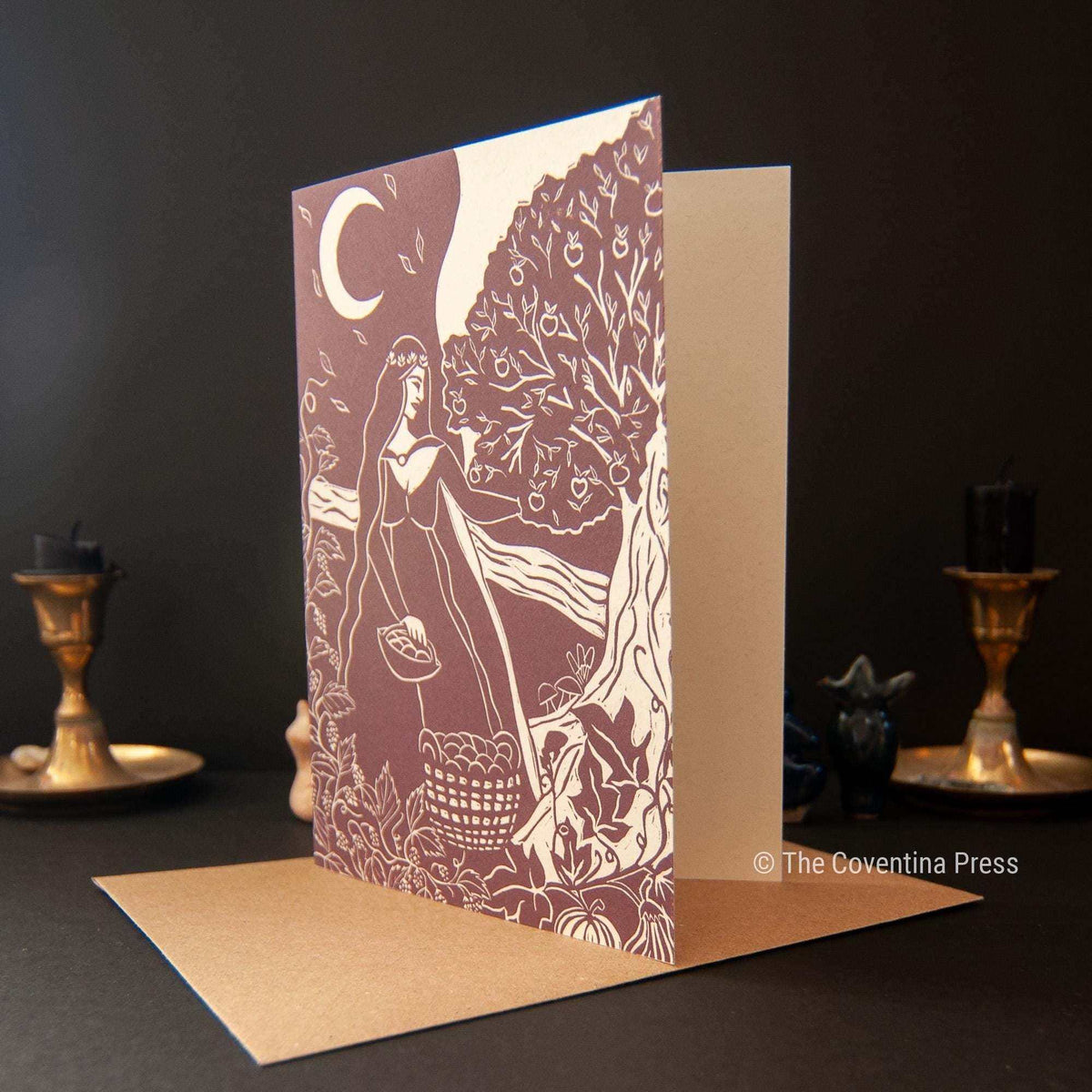 AUTUMN EQUINOX GREETING CARD with a mauve and cream linocut design of a woman beneath a fruiting tree