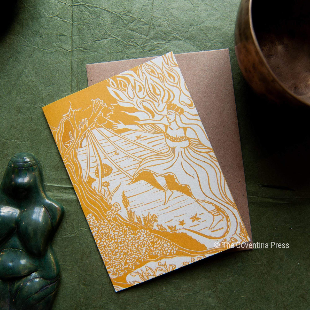 BELTANE GREETING CARD in orange and white, featuring a flowing-haired woman and landscape in a linocut-style design