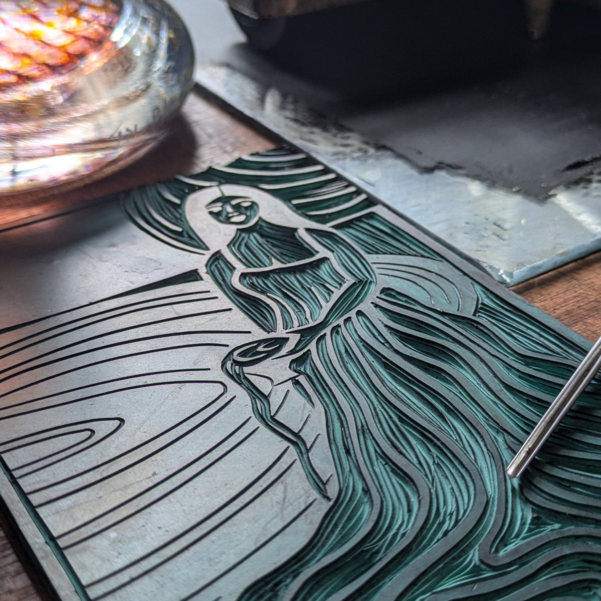 CIRCE ORACLE CARD featuring a teal and black linocut goddess with flowing hair and curved lines