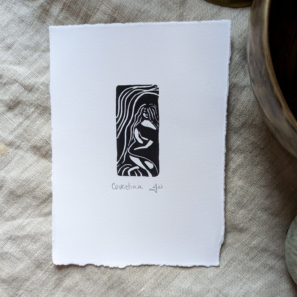 Miniature print COVENTINA BRITISH WATER GODDESS in black ink, showing a flowing-haired seated figure on white textured paper
