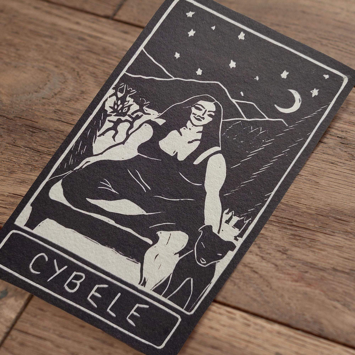 CYBELE ALTAR CARD in charcoal and ivory, with a bold linocut-style goddess, mountains, crescent moon and stars.