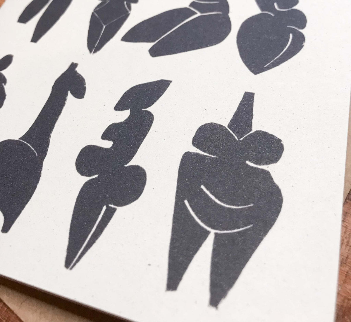 DANCING GODDESSES greeting card in natural cream cardstock, featuring bold black linocut silhouettes of stylized figures