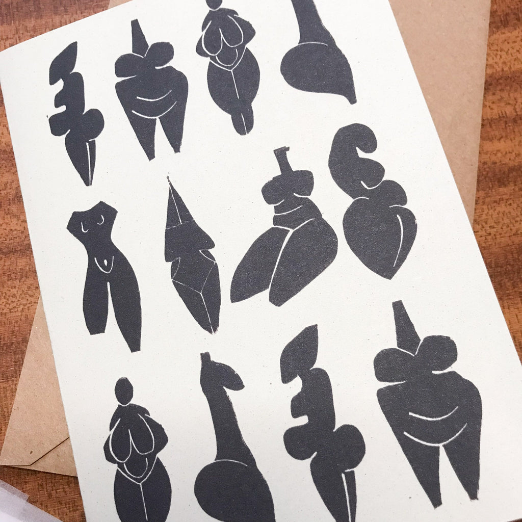 DANCING GODDESSES greeting card in cream recycled cardstock, featuring a black linocut of abstract prehistoric female figures