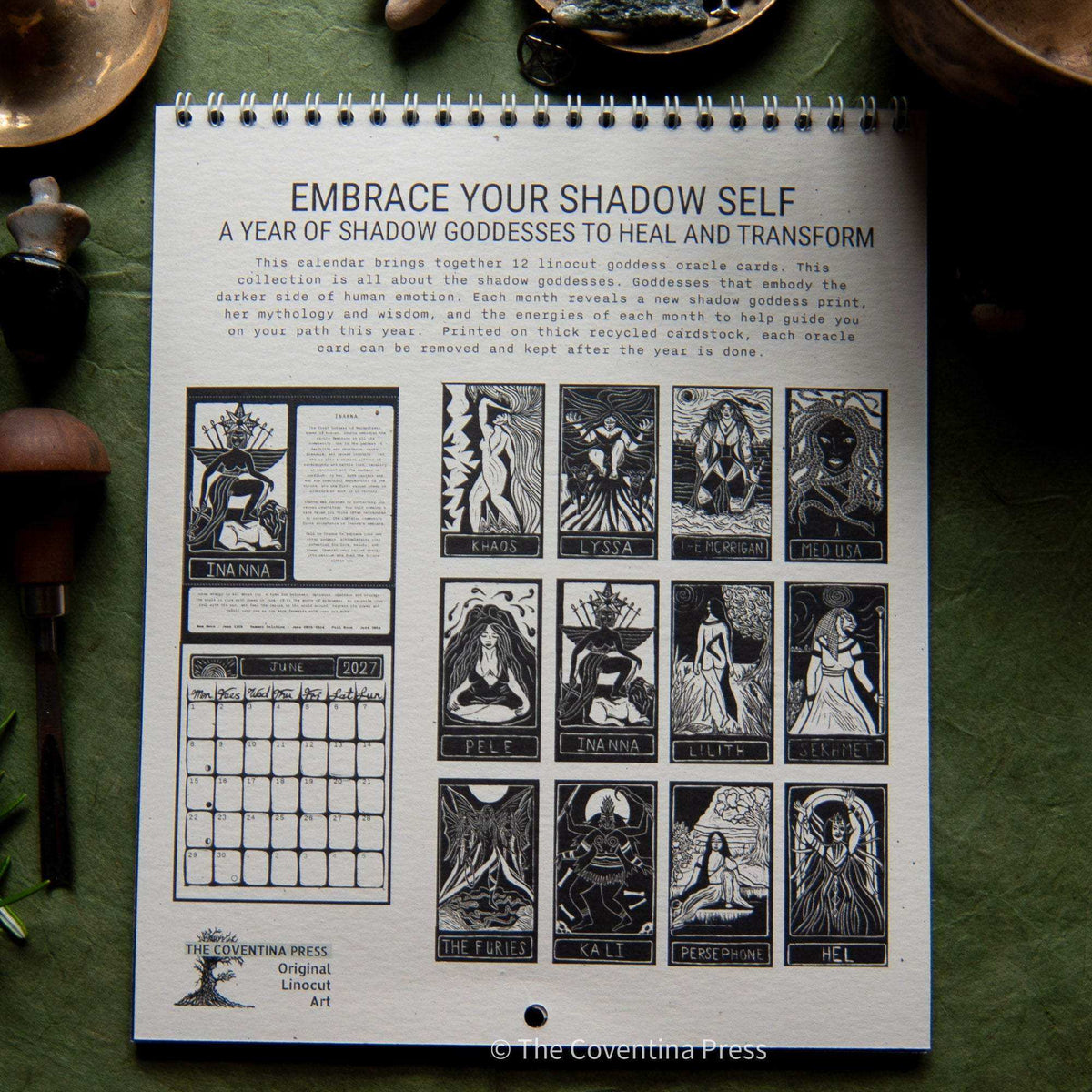 Dark Goddess Calendar 2027 with a spiral-bound page of black and white goddess linocuts and a monthly grid