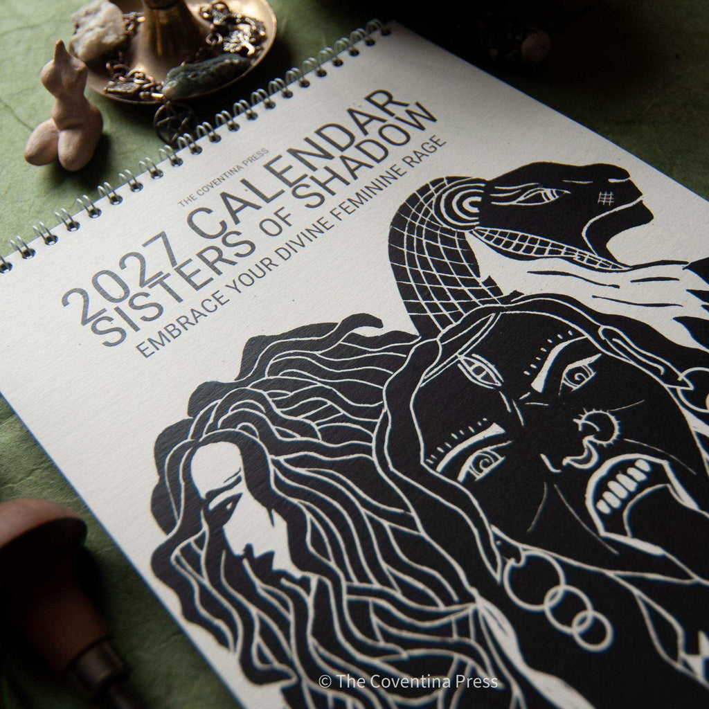 Dark Goddess Calendar 2027 with a black-and-white linocut cover showing intertwined goddess faces and spiral binding