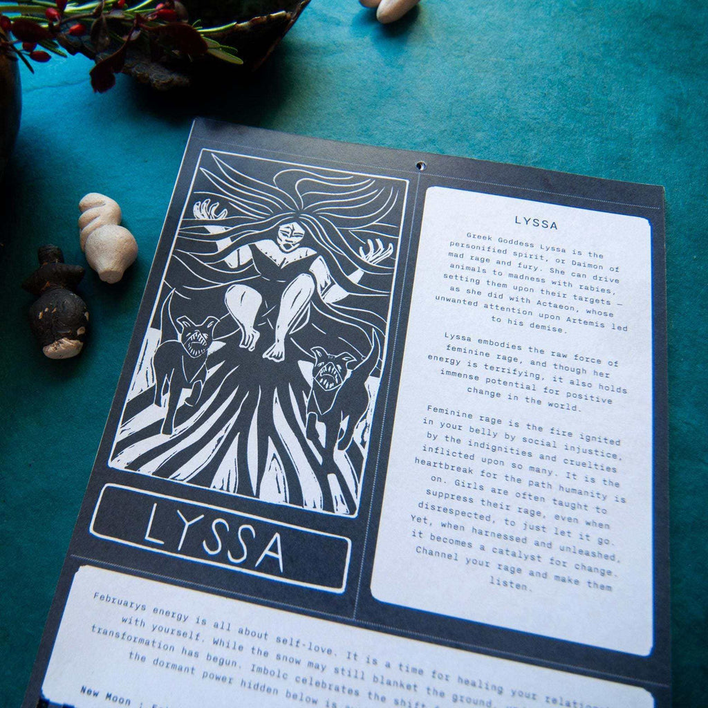 Dark Goddess Calendar 2027 with a black-and-white linocut of Lyssa, her name and mythology printed on a spiral-bound page