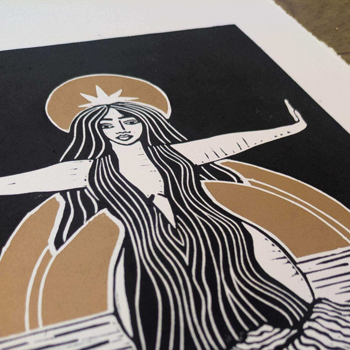 Divine Sophia Art linocut print in black, cream and ochre, showing a long-haired goddess with a halo