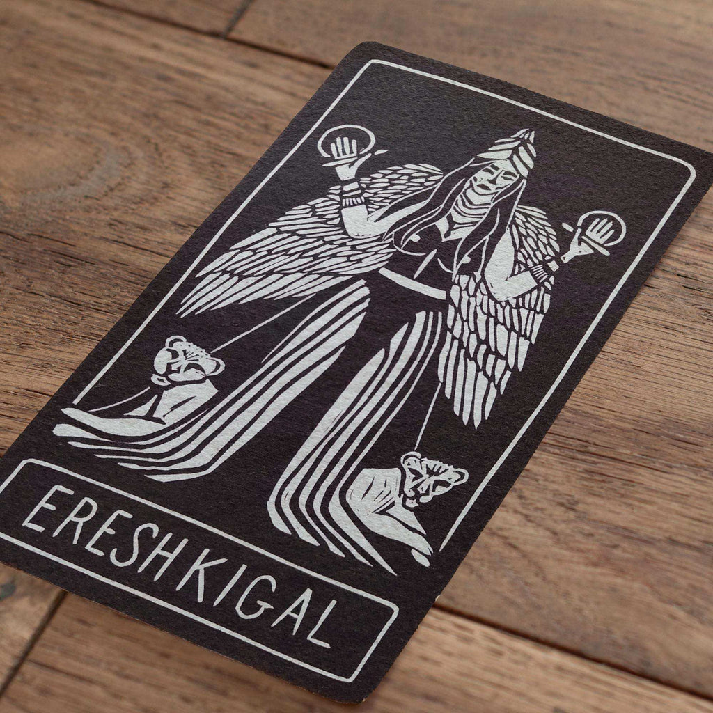 ERESHKIGAL ALTAR CARD with a black cotton rag card, white linocut goddess figure, wings and Ereshkigal lettering
