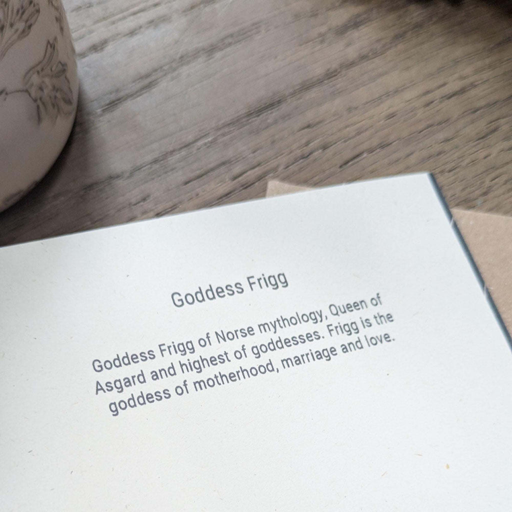 Frigg Greeting card in natural white recycled cardstock, with printed text about the Norse goddess Frigg and a blank interior.