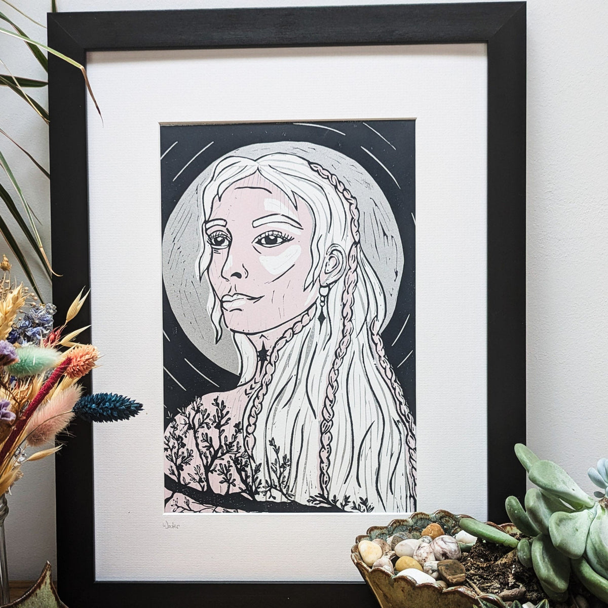 FRIGG | NORSE LOVE GODDESS linocut print showing a pale-haired woman with braids, black linework and a dark backdrop