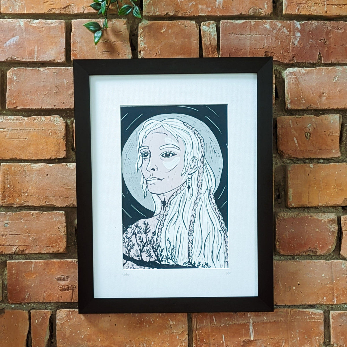 FRIGG | NORSE LOVE GODDESS linocut print in black and silver, featuring a braided-haired woman and foliage