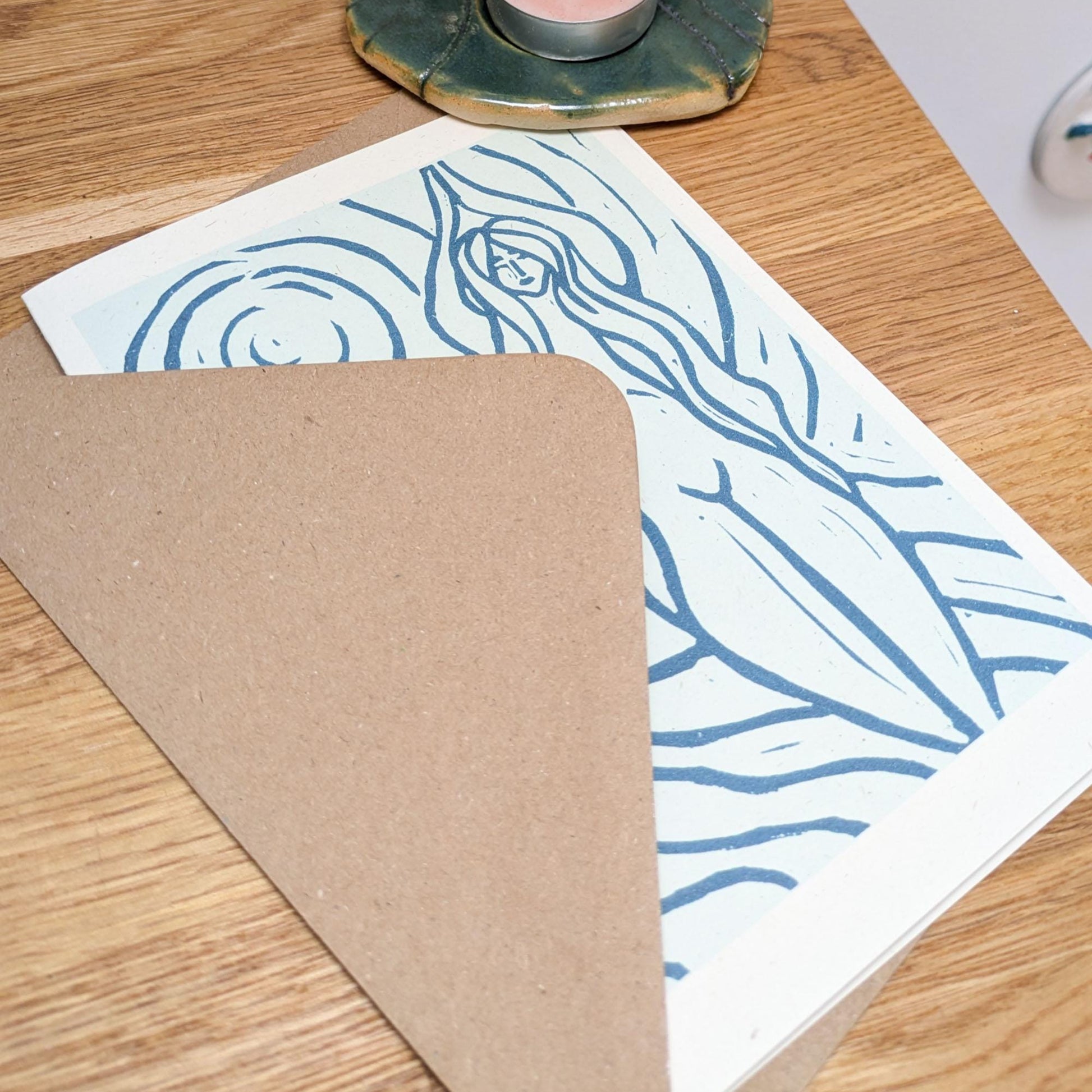 blue greeting card with naked woman the moon and water around her achelois