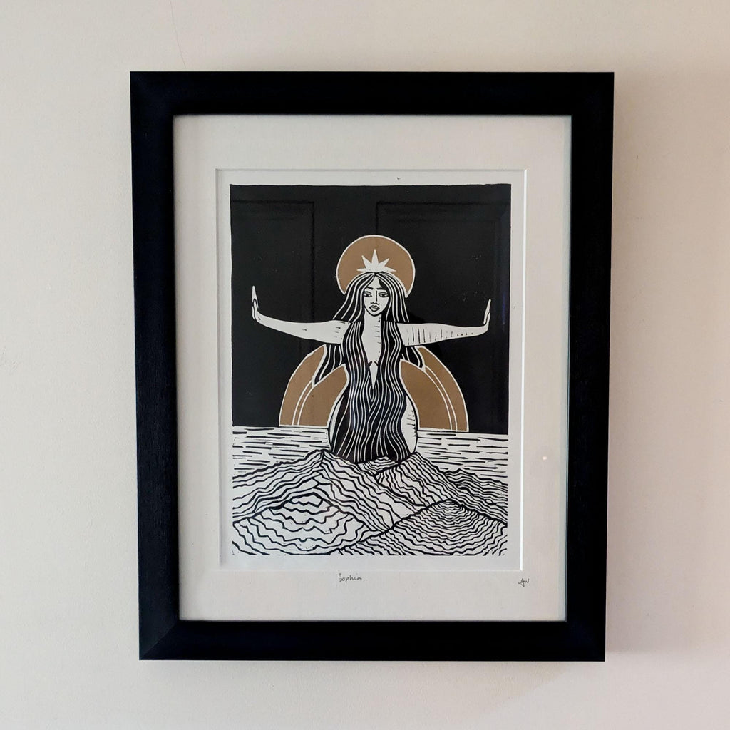 goddess sophia gold and black standing arms out in the sea