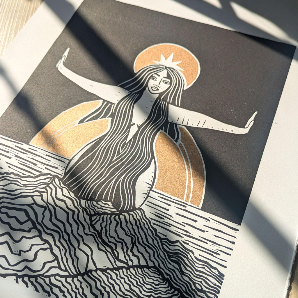 goddess sophia gold and black standing arms out in the sea
