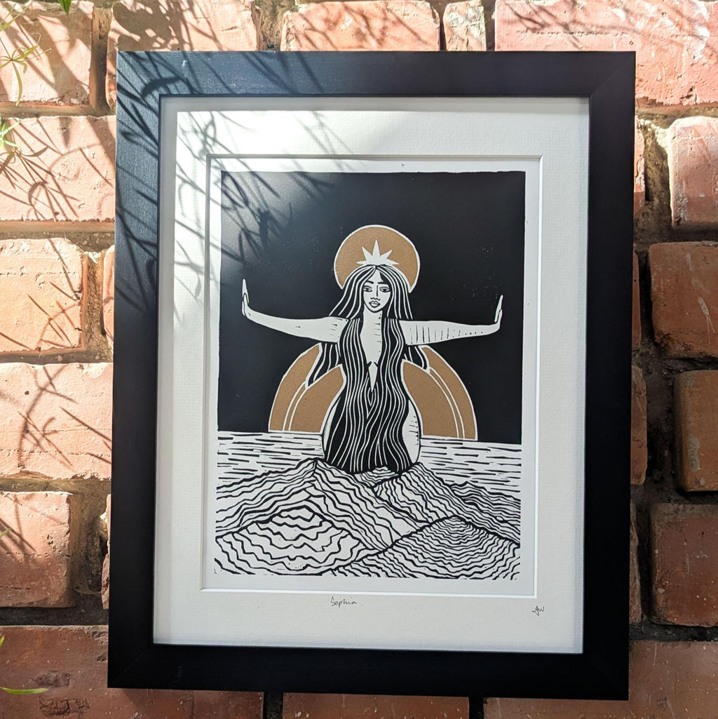 goddess sophia gold and black standing arms out in the sea