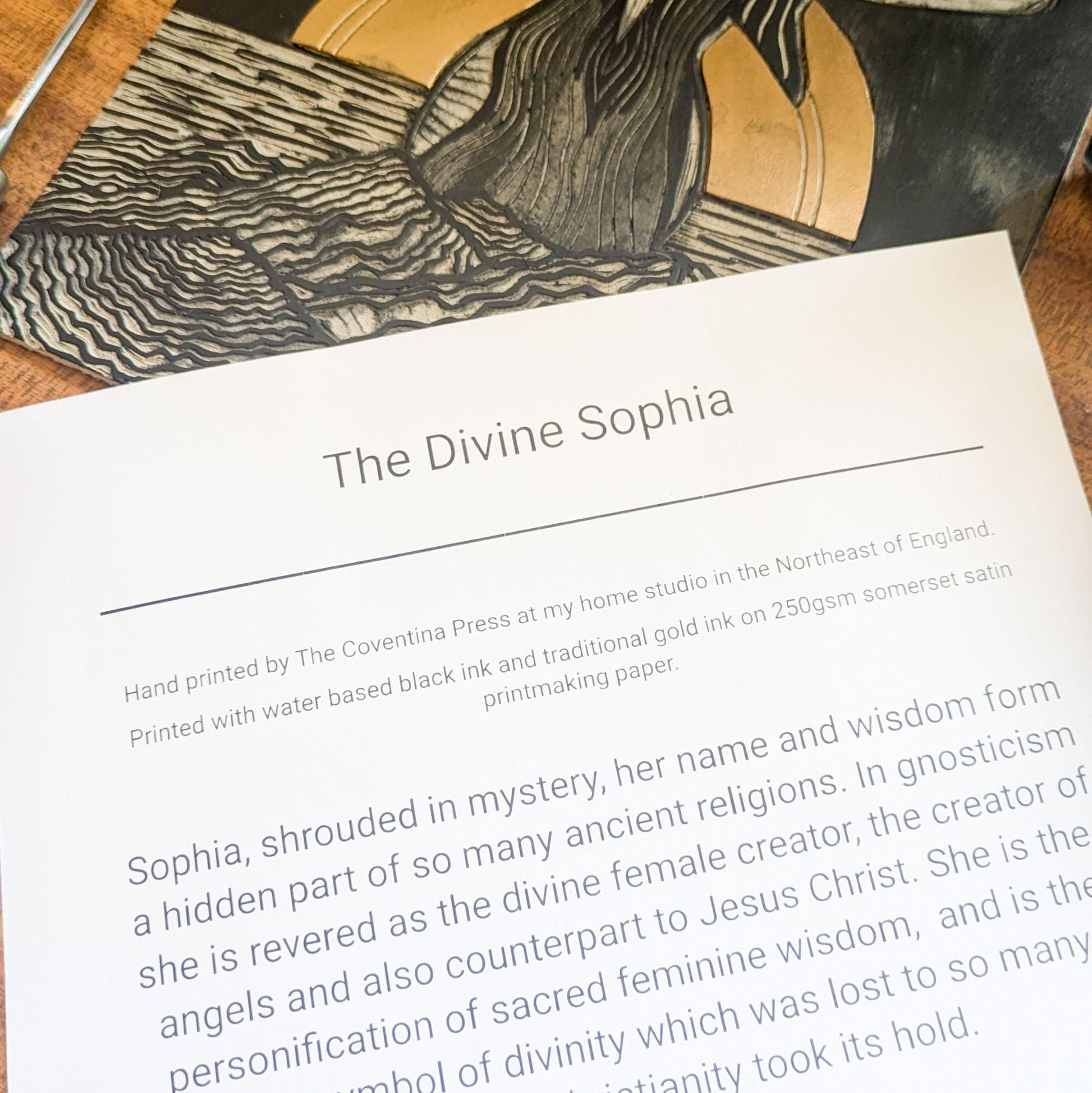 goddess sophia gold and black standing arms out in the sea