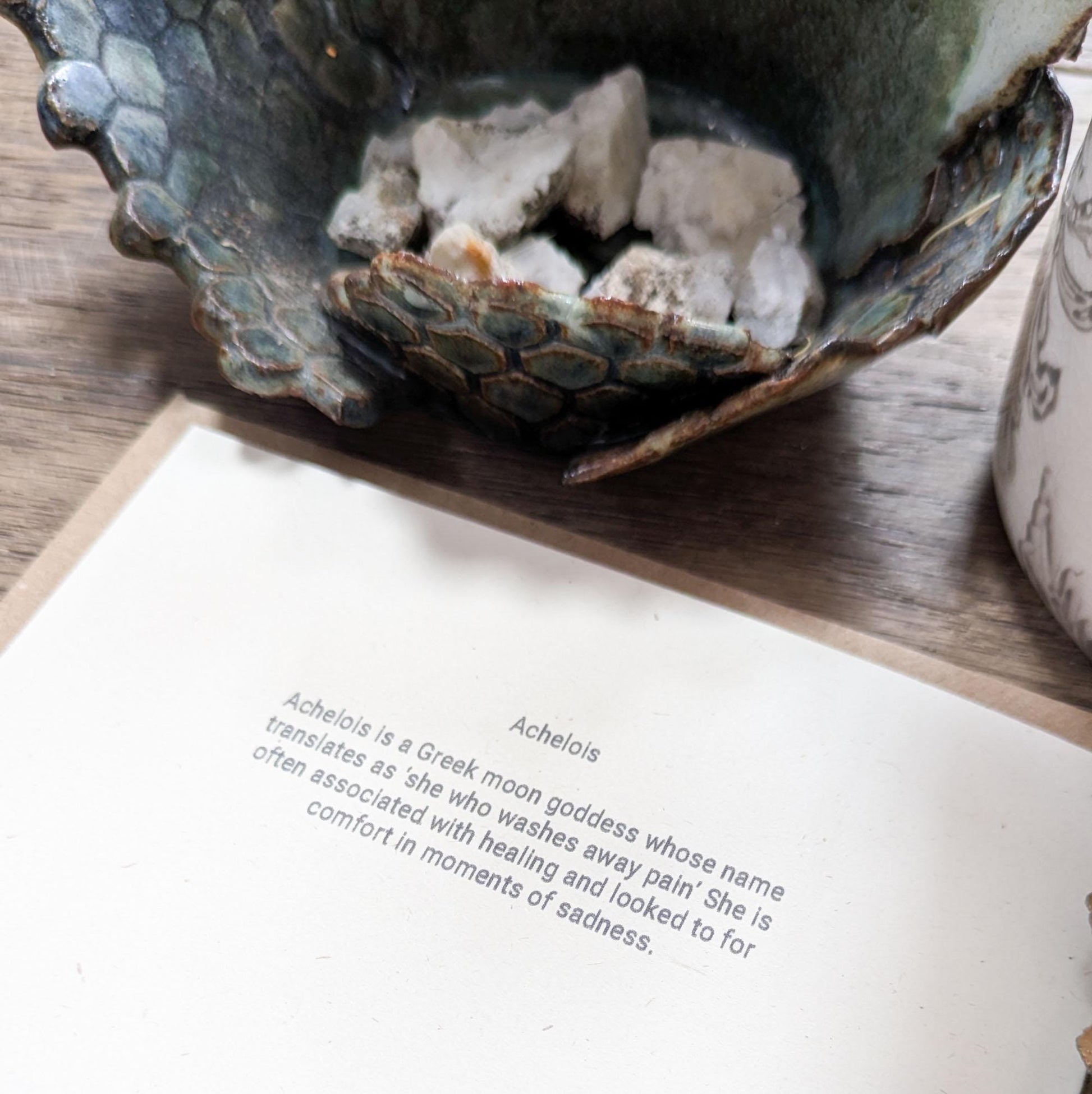 blue greeting card with naked woman the moon and water around her achelois