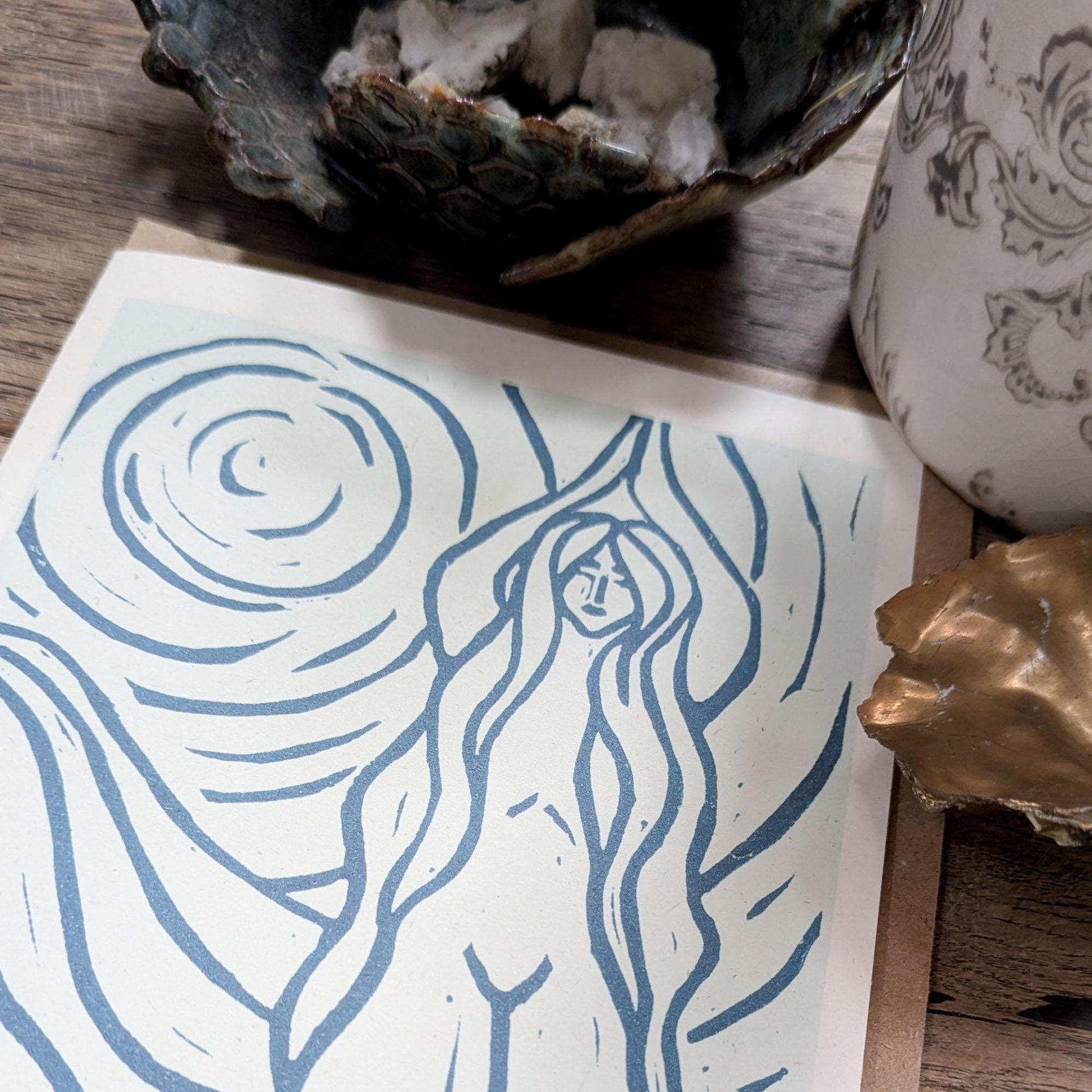 blue greeting card with naked woman the moon and water around her achelois