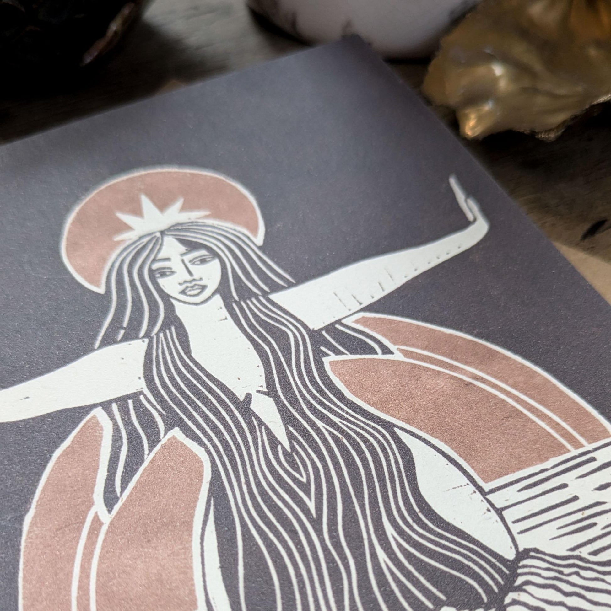 greeting card of divine sophia linocut print in black and dusky gold sun behind her