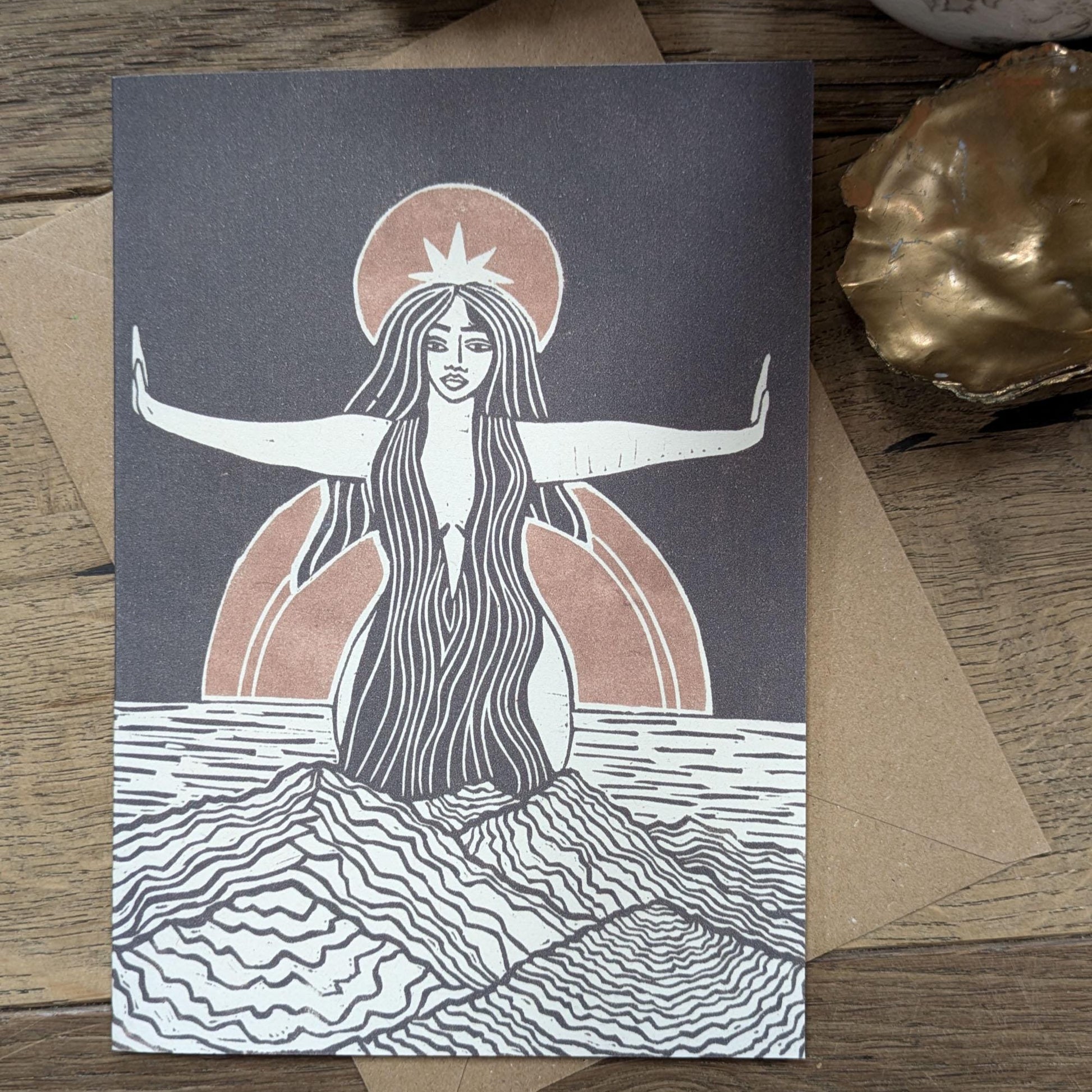 greeting card of divine sophia linocut print in black and dusky gold sun behind her