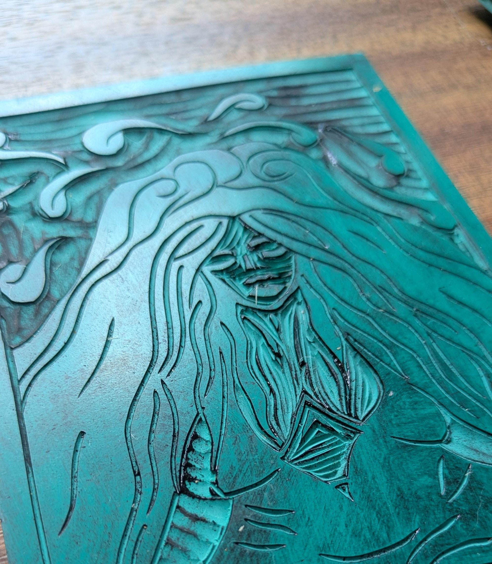 linocut goddess oracle card in black and white, Goddess Pele crozzed legs at the bottom of a volcano