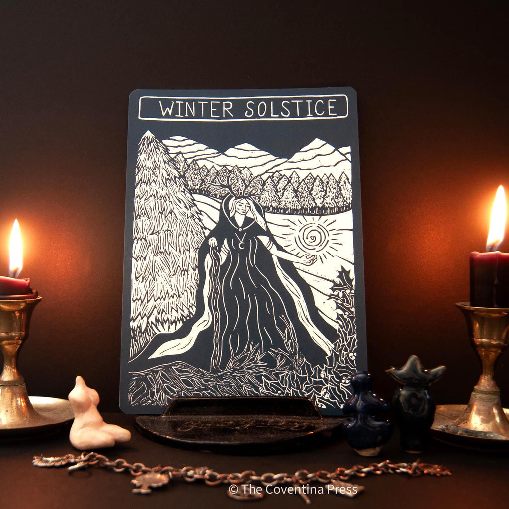 WINTER SOLSTICE altar card in black and white, featuring a linocut-style robed figure among trees and mountains