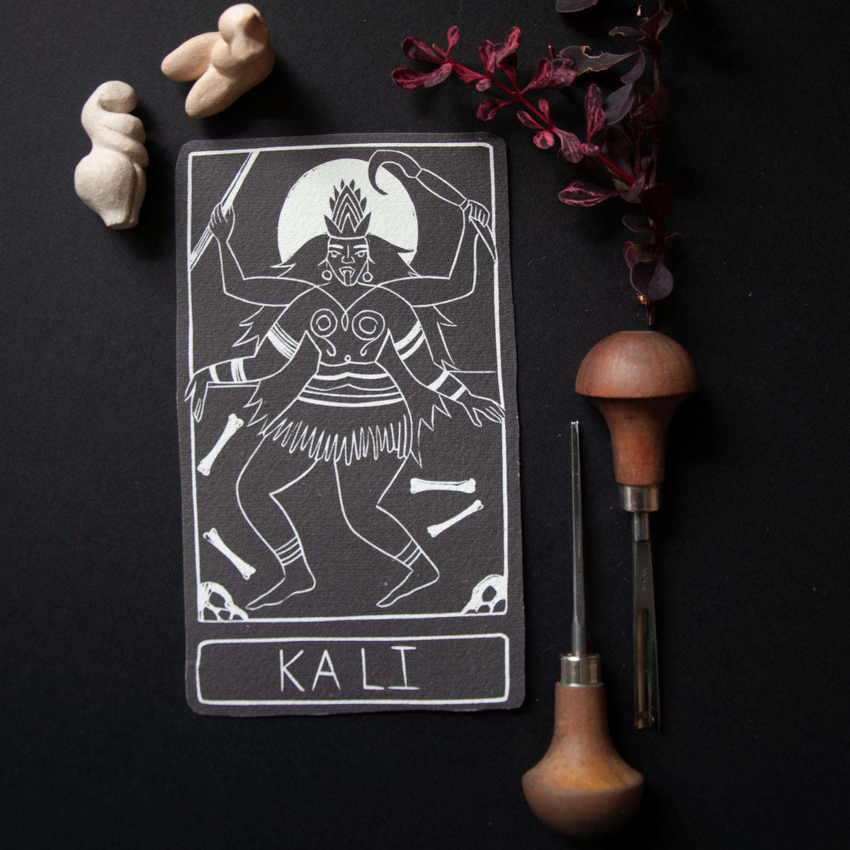 KALI ALTAR CARD featuring a black cotton rag card with a white linocut of multi-armed Kali and a nameplate