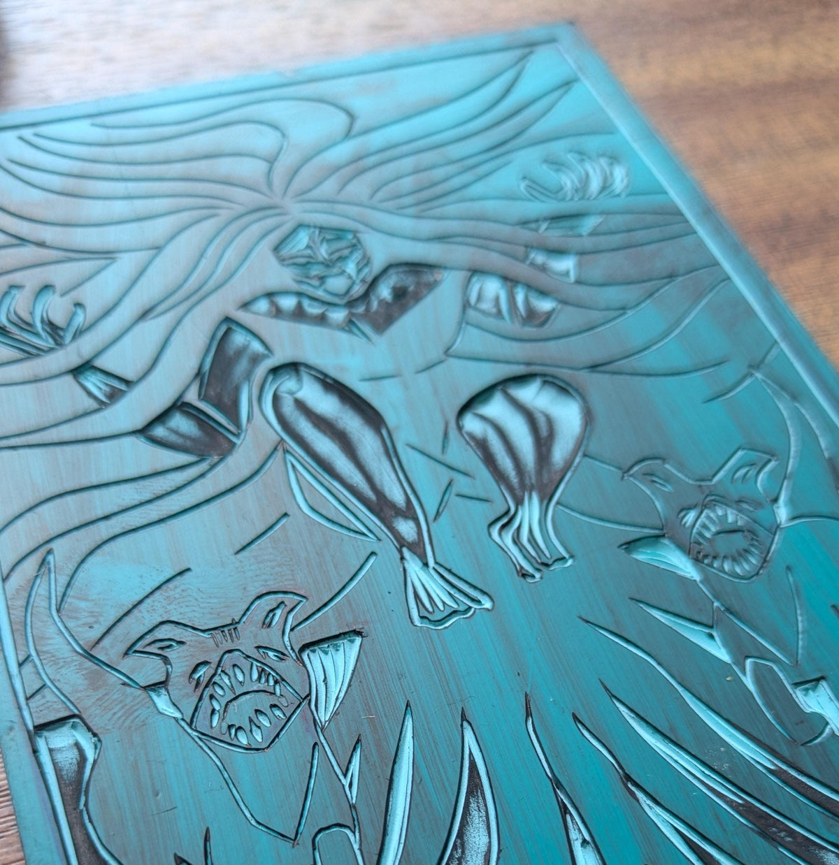 KALI ALTAR CARD linocut block with a goddess figure, flowing hair and animal forms etched into blue-green material
