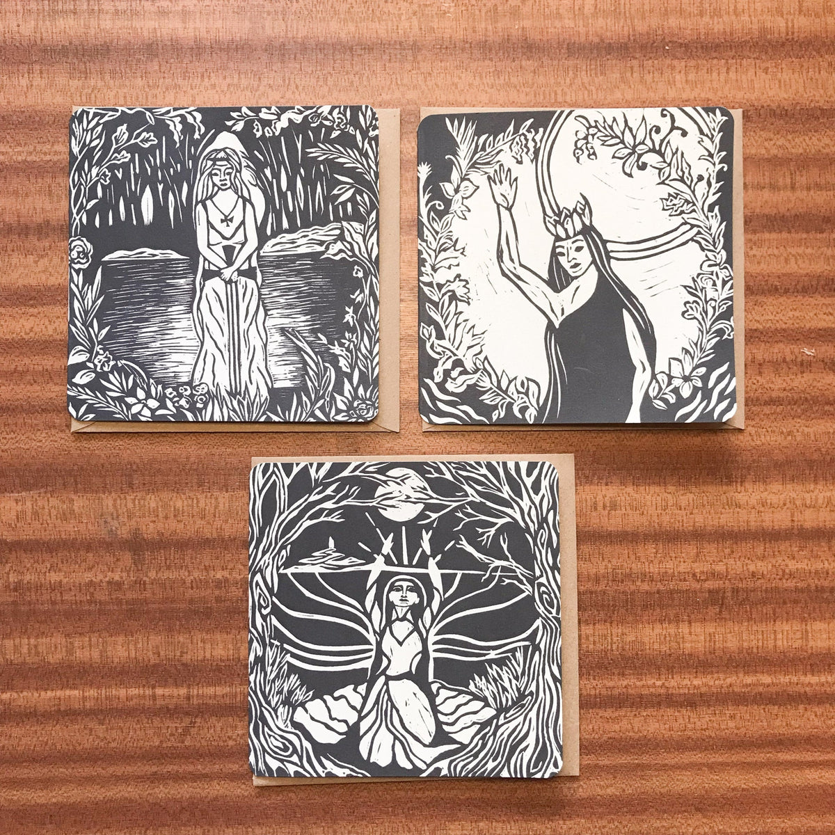 MORGANA LE FAY Greeting card with a black-and-white linocut of a robed woman amid intricate foliage on natural cardstock