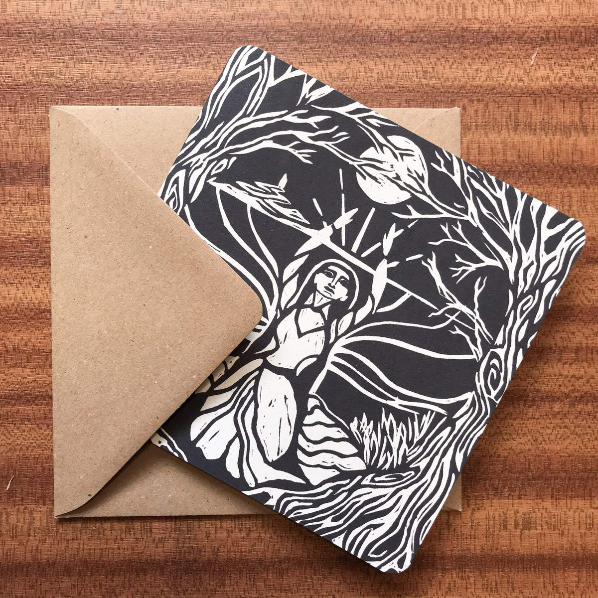 MORGANA LE FAY Greeting card in natural cardstock, with a black-and-white linocut of a woman among twisting branches