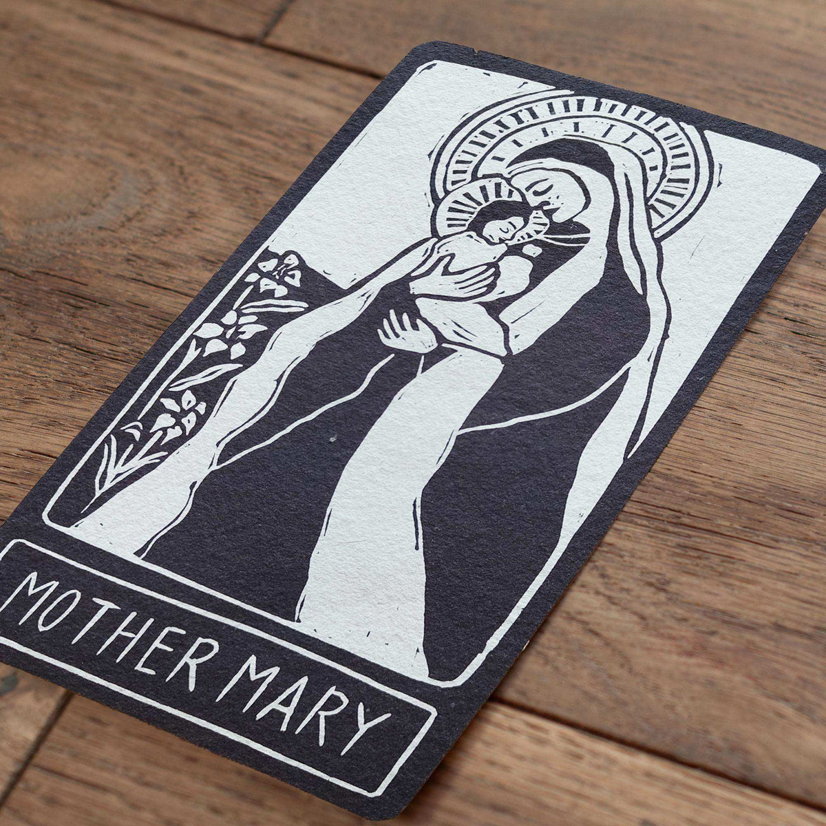 MOTHER MARY ALTAR CARD in black and white, featuring a linocut-style image of Mary holding a child and a halo