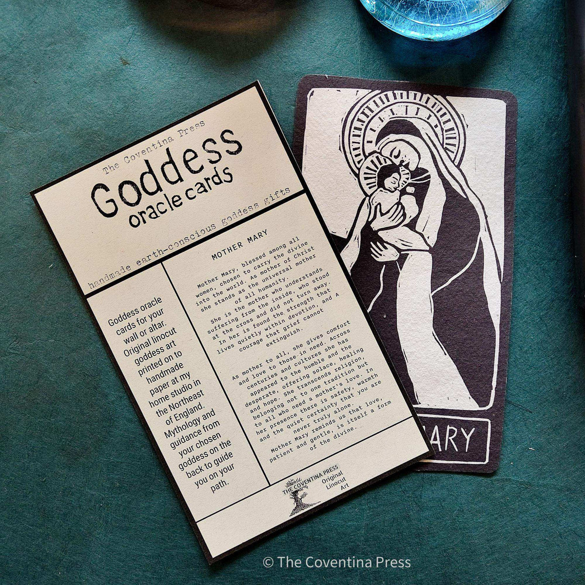 MOTHER MARY ALTAR CARD with a black-and-cream linocut of Mary holding a child, alongside its printed mythology insert.