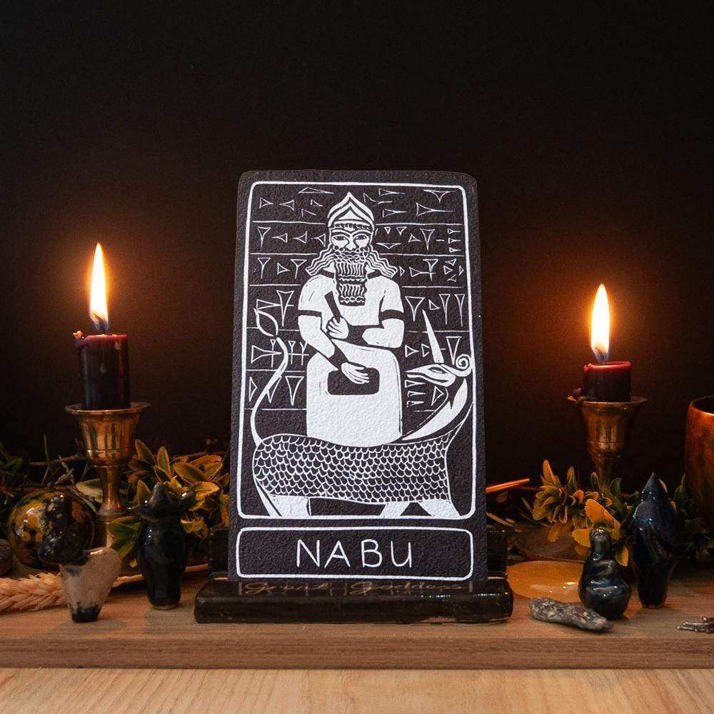NABU ALTAR CARD with a white linocut-style figure and cuneiform motifs on a dark card, labeled Nabu