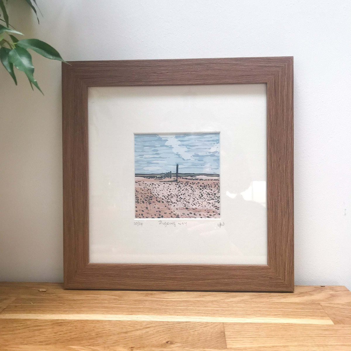 PILGRIM'S WAY linocut print showing a sandy coastal landscape, blue sky and distant horizon in muted colours