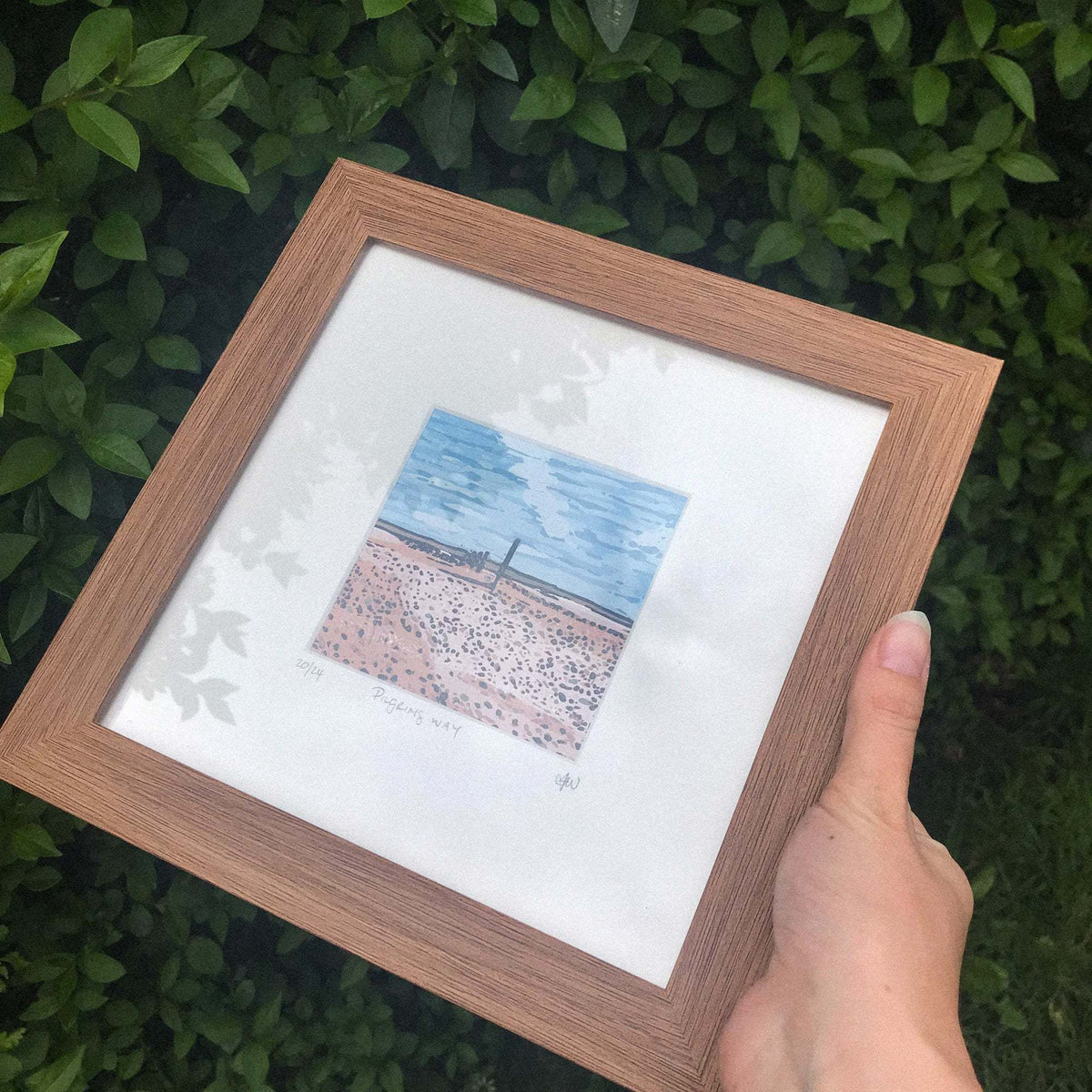 PILGRIM'S WAY linocut print with a blue sky, coastal path and muted pink sandy landscape, signed and mounted
