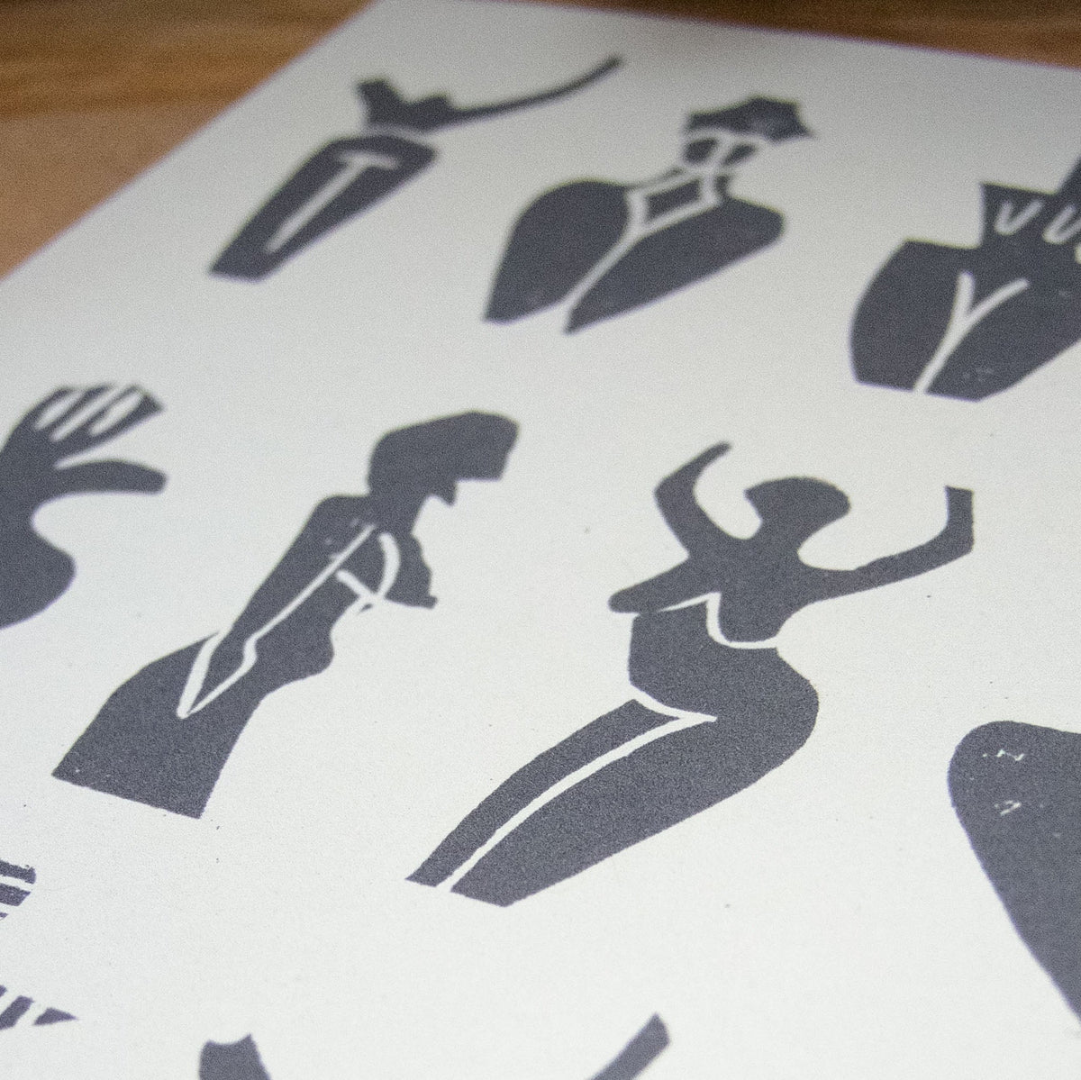 PREHISTORIC GODDESS GREETING CARD in natural white cardstock, featuring a black linocut print of dancing goddess figures.