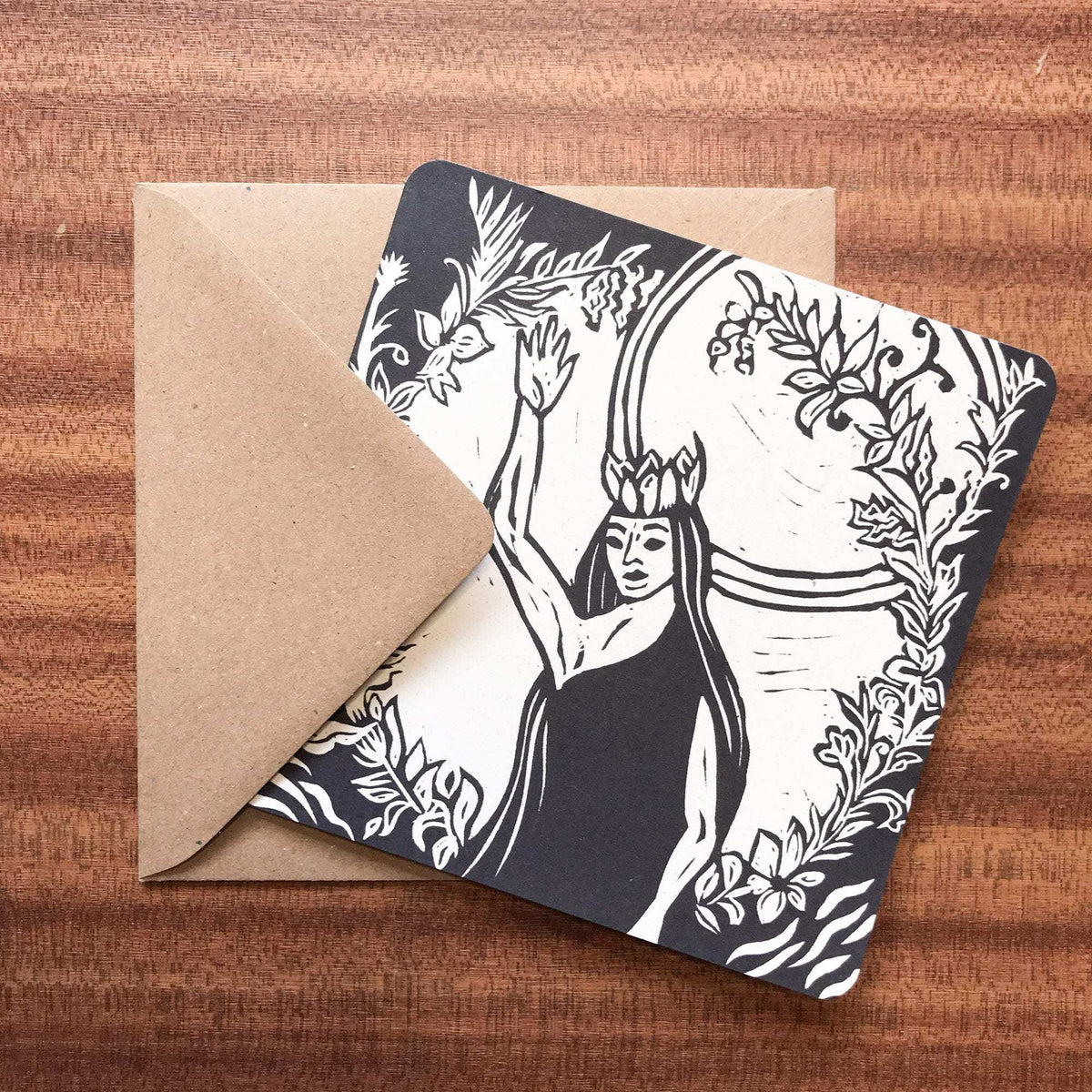 QUEEN ELPHAME greeting card in cream and black, featuring a detailed linocut of a crowned queen amid botanical motifs