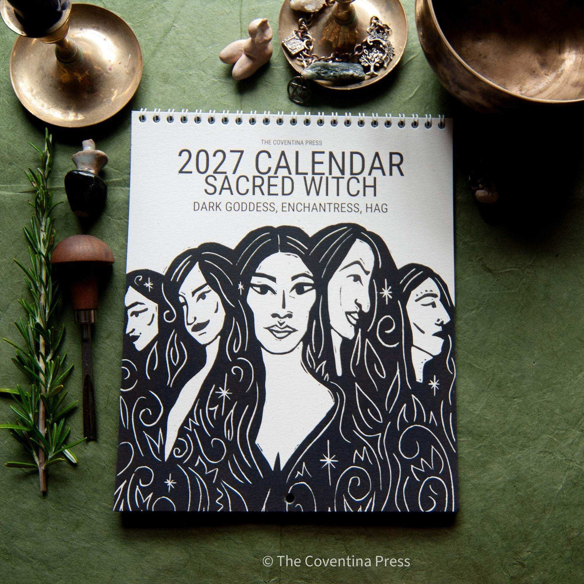 SACRED WITCH 2027 wall calendar with black-and-white linocut art of five goddesses and metal spiral binding
