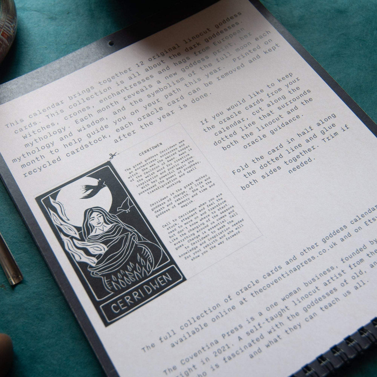 SACRED WITCH calendar page with a black-and-white linocut of Cerridwen, mythology text and metal spiral binding