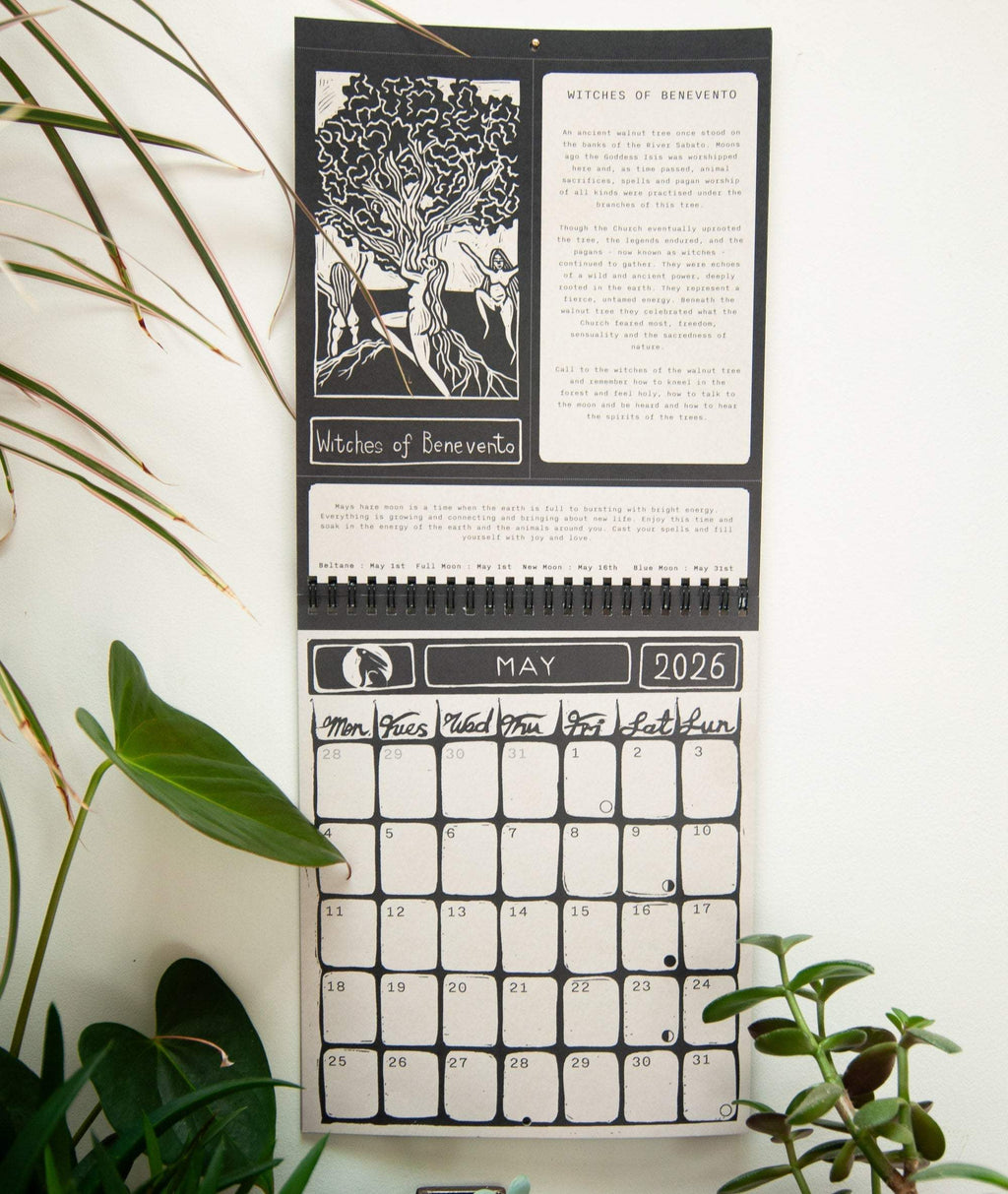 SACRED WITCH wall calendar with black-and-white goddess linocut art, metal spiral binding and a May 2026 monthly grid