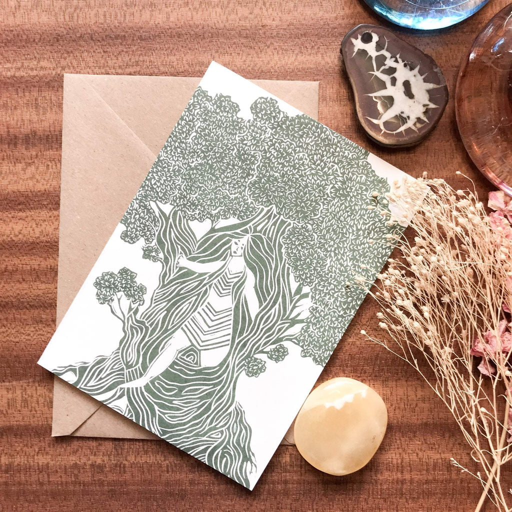 THE DRYAD greeting card with a green and white linocut of a tree spirit among leafy branches on white cardstock